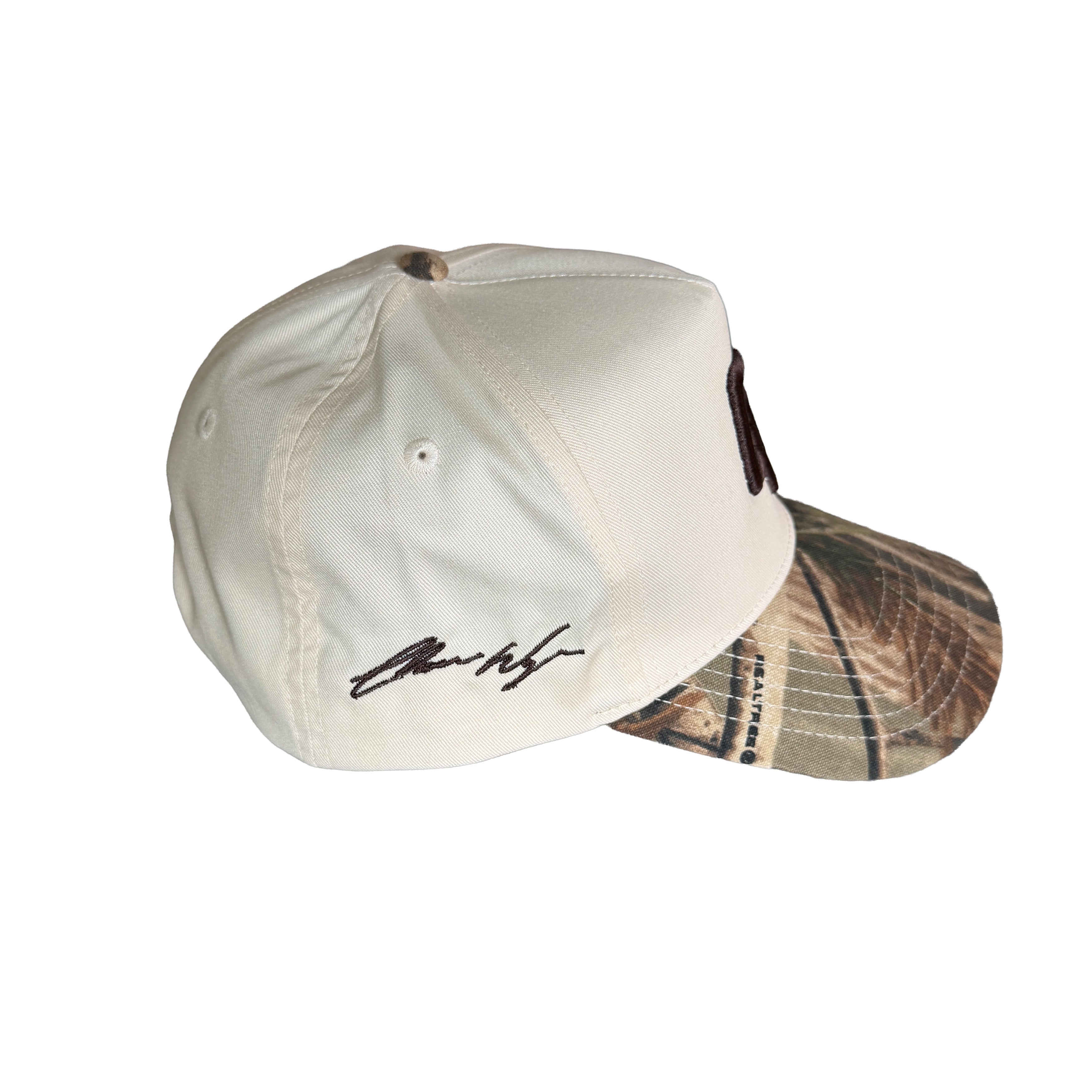 Two baseball caps, one beige and one with a camouflage pattern, on a white background.